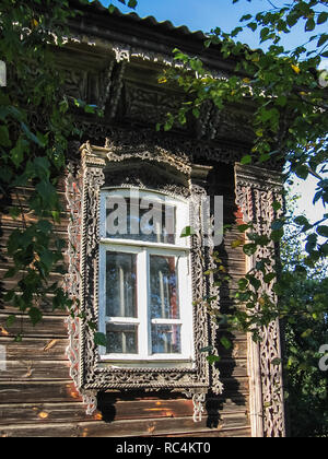 Plinths of windows of wooden houses. Ancient style of decoration of window frames. Stock Photo