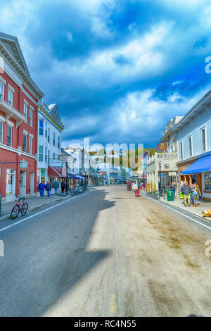 Main Street Mackinac Island, Michigan / United States - October 16, 2018:  Tourists enjoying the island on a windy day in October. Stock Photo