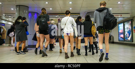 Participants are seen at the Paddington Station walking toward the train during  the 10th anniversary of  'No Trousers Tube Ride'. The No Pants Subway Ride is an annual event staged by Improve Everywhere every January in New York City. The mission started as a small prank with seven guys and has grown into an international celebration of silliness, with dozens of cities including London around the world participating each year. Stock Photo