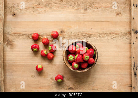 Fresh strawberries on wooden background, top view. Copy space for text. Harvest of fresh organic strawberries Stock Photo