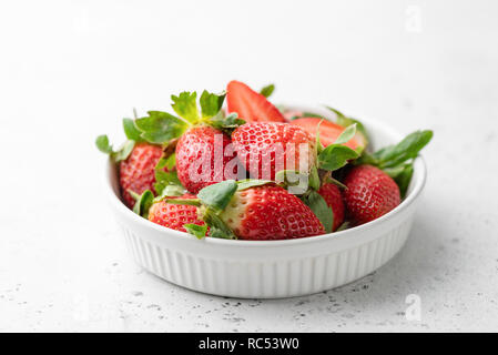 Fresh strawberries in bowl on white background, horizontal view, selective focus. Tasty strawberries. Healthy food