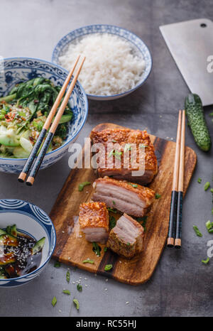 Chinese crispy skin pork belly with bok choy and cucmbers Stock Photo