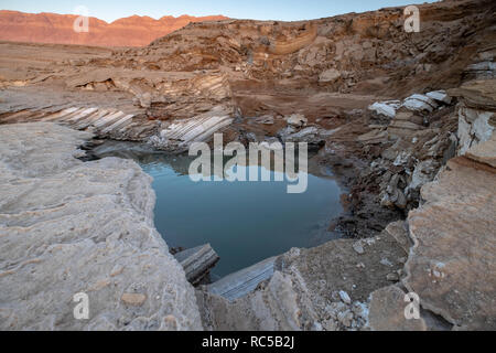 Israel, Dead Sea A sinkhole caused by the receding water level of the Dead Sea. A hot water spring fills the hole Stock Photo