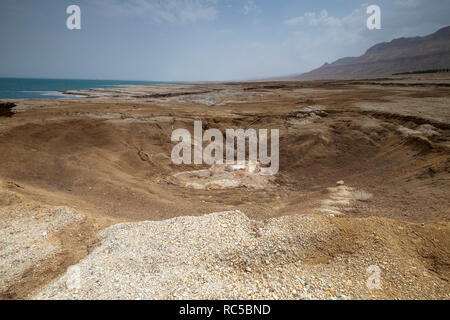 Israel, Dead Sea A sinkhole caused by the receding water level of the Dead Sea. A hot water spring fills the hole Stock Photo