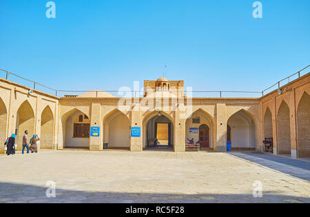 YAZD, IRAN - OCTOBER 18, 2017: The courtyard of Jameh Mosque with brick arched gallery and small domes, on October 18 in Yazd. Stock Photo