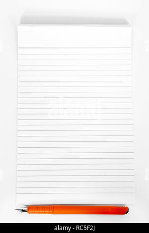 Picture of notepad with orange pen. Isolated on the white background. Stock Photo
