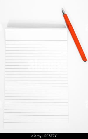 Picture of notepad with orange pen. Isolated on the white background. Stock Photo