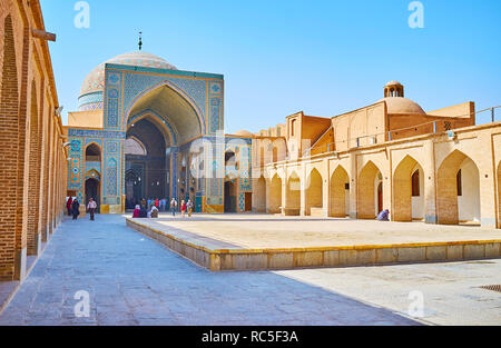 YAZD, IRAN - OCTOBER 18, 2017: Jameh Mosque boasts large courtyard with brick arcades, ornate tiled portal and huge dome, on October 18 in Yazd. Stock Photo