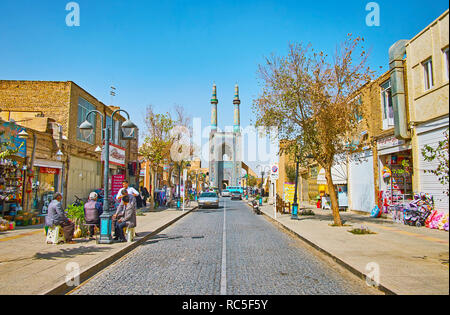 YAZD, IRAN - OCTOBER 18, 2017: The narrow Masjid Jame street is lined with tourist restaurants, souvenir stalls and small hotels, the Friday Mosque wi Stock Photo