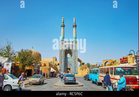 YAZD, IRAN - OCTOBER 18, 2017: The dense car parking, market stalls and crowds of people at the Friday mosque make Masjid Jame one of the busiest tour Stock Photo