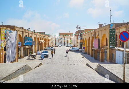 YAZD, IRAN, OCTOBER 18, 2017: The alley of Khan Bazaar with lines of the stores and portal of Mulla Ismael Mosque on the background, on October 18 in  Stock Photo