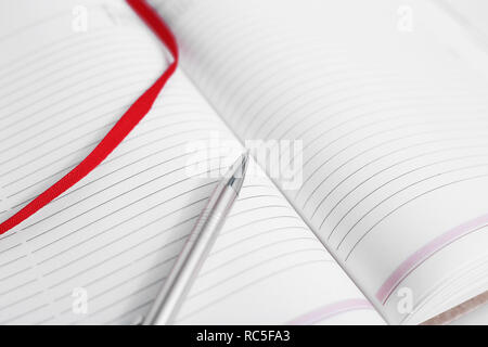 Portrait of open diary with pen. Isolated on the white background. Stock Photo