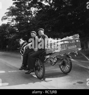 Two men seated on a horse and cart on a road, West Yorkshire, 1966-1974. Creator: Eileen Deste. Stock Photo