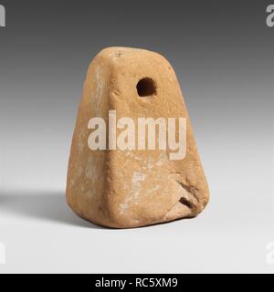 Terracotta loom weight. Culture: Lydian. Dimensions: Length: 2 5/8 in. (6.6 cm). Date: 6th century B.C. or later.  Loom weight with hole. Museum: Metropolitan Museum of Art, New York, USA. Stock Photo