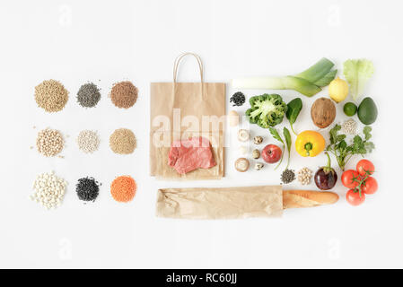 Full paper bag of different health food on white background. Top view. Flat lay Stock Photo