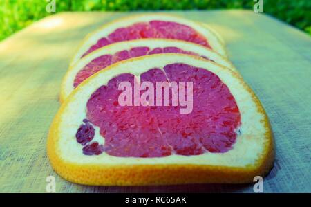 Grapefruit slices on wood Stock Photo