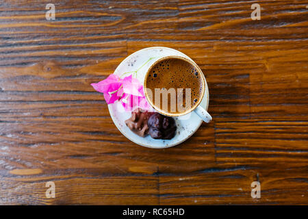 Turkish or Greek Coffee on wooden table from top view. Traditional tasty refreshment hot coffee in coffee cup Stock Photo