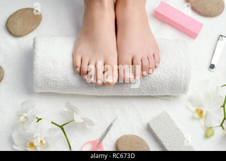Female feet on towel roll Stock Photo