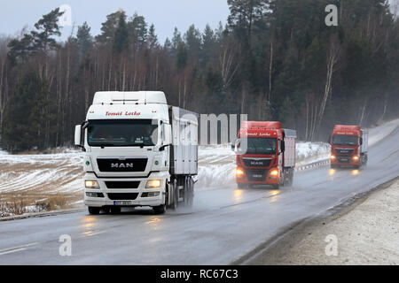 Salo, Finland - January 4, 2019: Fleet of three MAN semi trucks of Tomas Lotko, Czech Republic platooning on Finnish highway 52 on a day of winter.