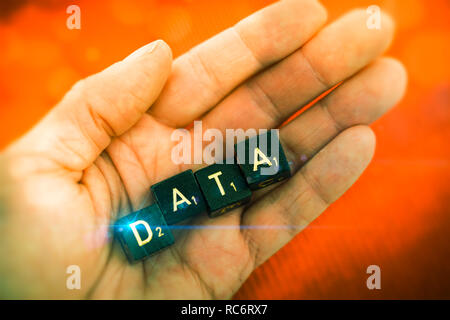 Letter cubes forming the word data on a hand Stock Photo