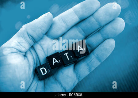 Letter cubes forming the word data on a hand Stock Photo