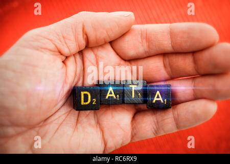 Letter cubes forming the word data on a hand Stock Photo