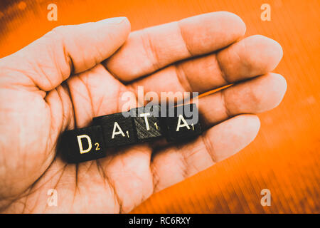 Letter cubes forming the word data on a hand Stock Photo