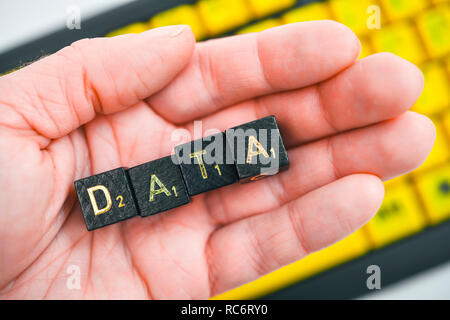 Letter cubes forming the word data on a hand Stock Photo