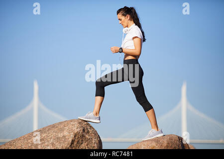 Sporty woman stepping on stones Stock Photo