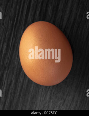 whole chicken egg closeup on wooden background Stock Photo