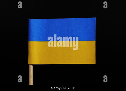 A official flag of Ukraine on toothpick on black background. A horizontal bicolour of blue and yellow. Stock Photo