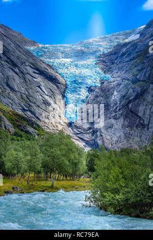 Briksdal or Briksdalsbreen glacier with melting blue ice, Norway nature landmark and turquoise river Stock Photo