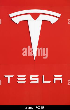Tilst, Denmark - October 7, 2018: Tesla logo on a wall. Tesla is an American automotive and energy storage company Stock Photo