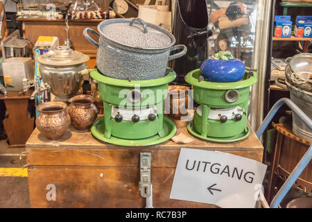 old oil stoves and pots and pans on top of a wooden box on a market Stock Photo