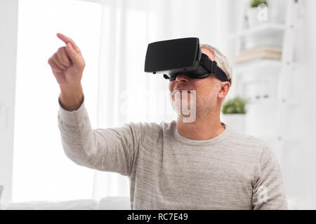 old man in virtual reality headset or 3d glasses Stock Photo