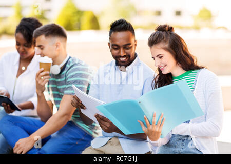 international students with notebooks outdoors Stock Photo