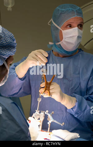Doctors performing spine surgery using neuronavigation computer-assisted technology system Stock Photo
