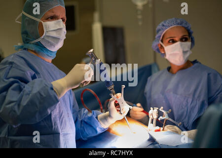 Doctors performing spine surgery using neuronavigation computer-assisted technology system Stock Photo
