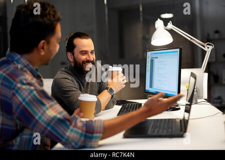 creative team drinking coffee at night office Stock Photo