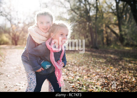 Sisters playing in forest Stock Photo