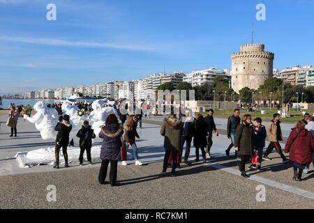 People walk around statues by the Chinese artist  Xu Xongfei exhibited  in Thessaloniki, Greece, between December 17 and December 24, 2018. Stock Photo