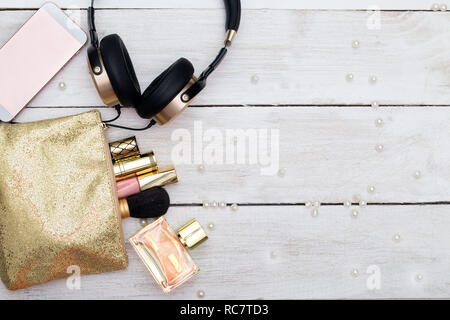 Decorative cosmetics and accessories for makeup on white wooden background Stock Photo