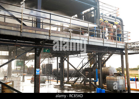 Firemen training, on training facility building spraying water Stock Photo