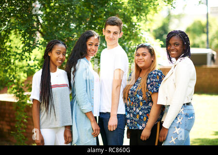 Teenage boy and higher education students on college campus, portrait Stock Photo