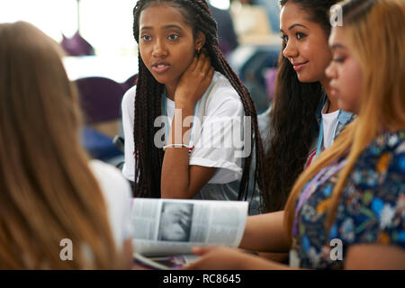 Female higher education students discussing project in college classroom Stock Photo