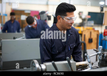 Student operating machine in workshop Stock Photo