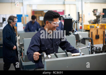 Student operating machine in workshop Stock Photo
