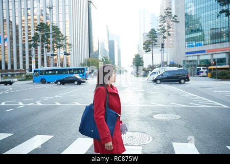 Businesswoman on pedestrian crossing in city, Seoul, South Korea Stock Photo