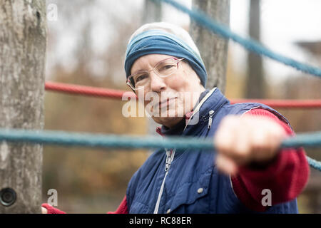 Senior woman exercising in park Stock Photo