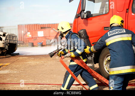 Firemen and fire engine in training centre, Darlington, UK Stock Photo